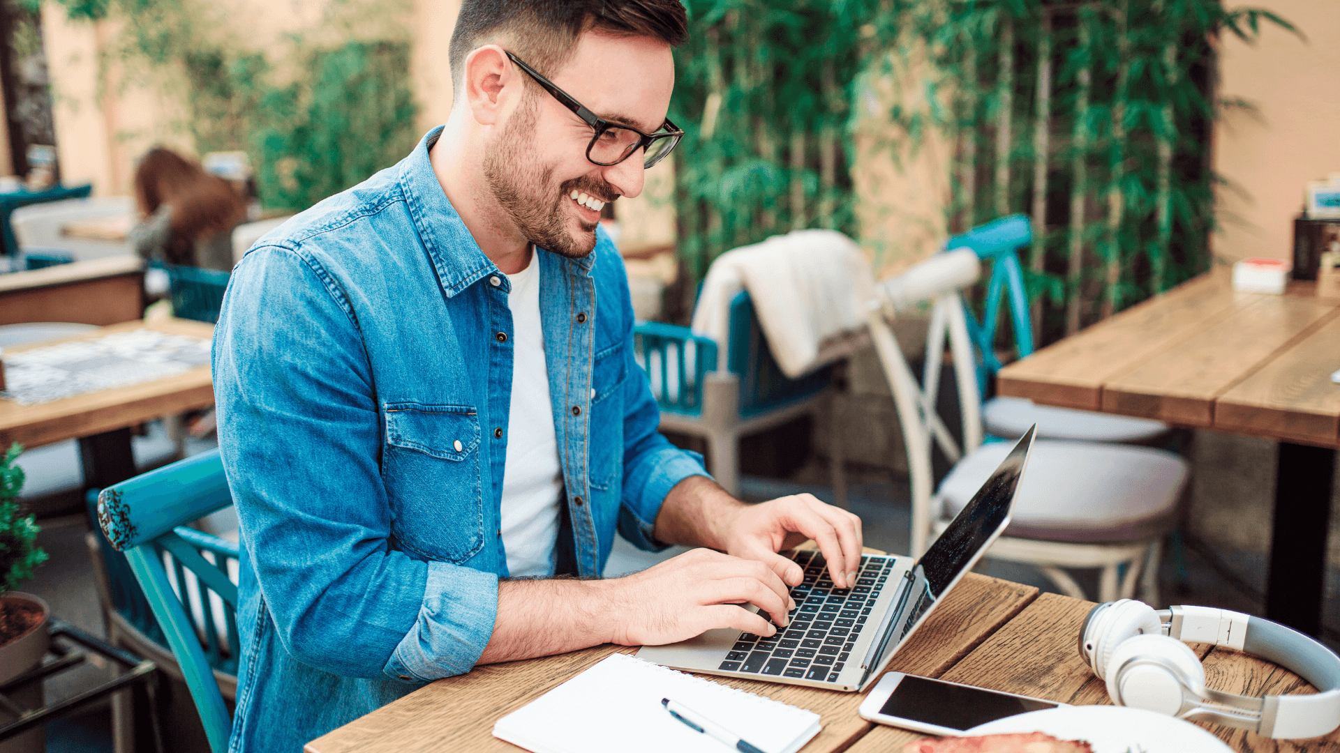 Smiling man building a church website on his laptop